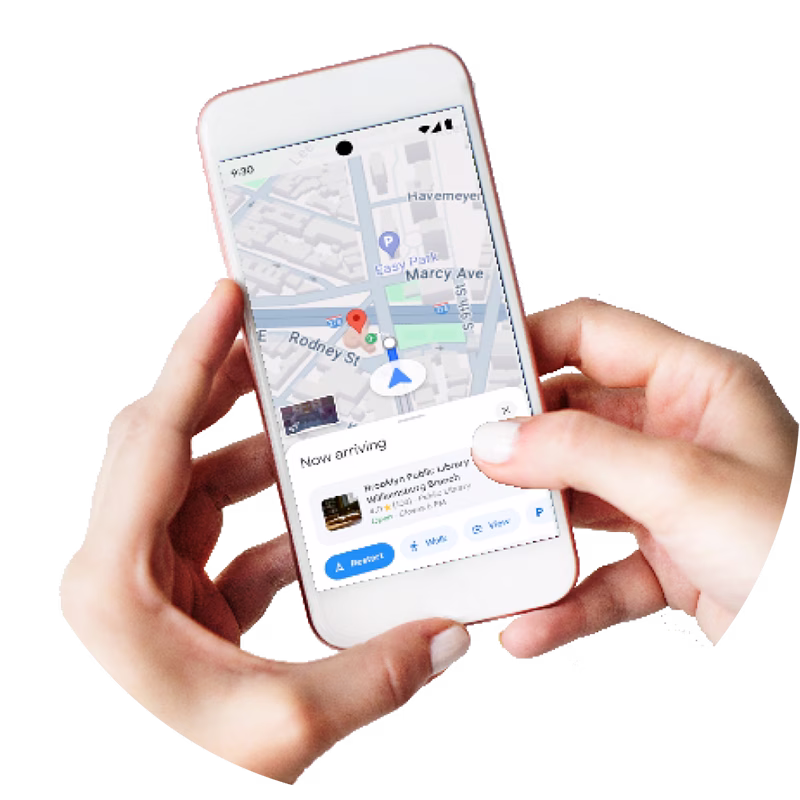 Person holding a smartphone displaying a navigation map